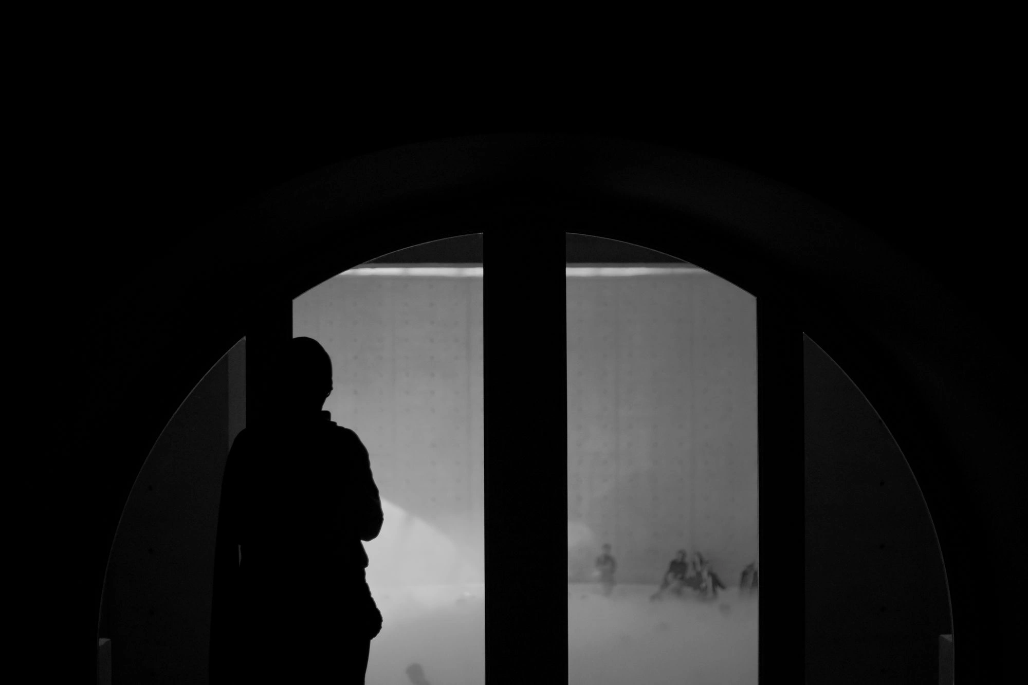 Person standing in front of window in shadow