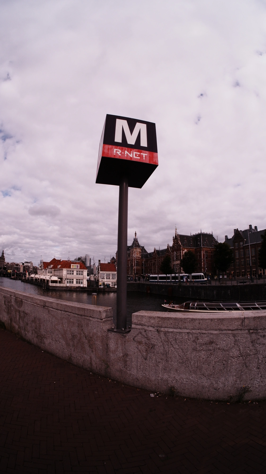Metro sign with canal central station in background