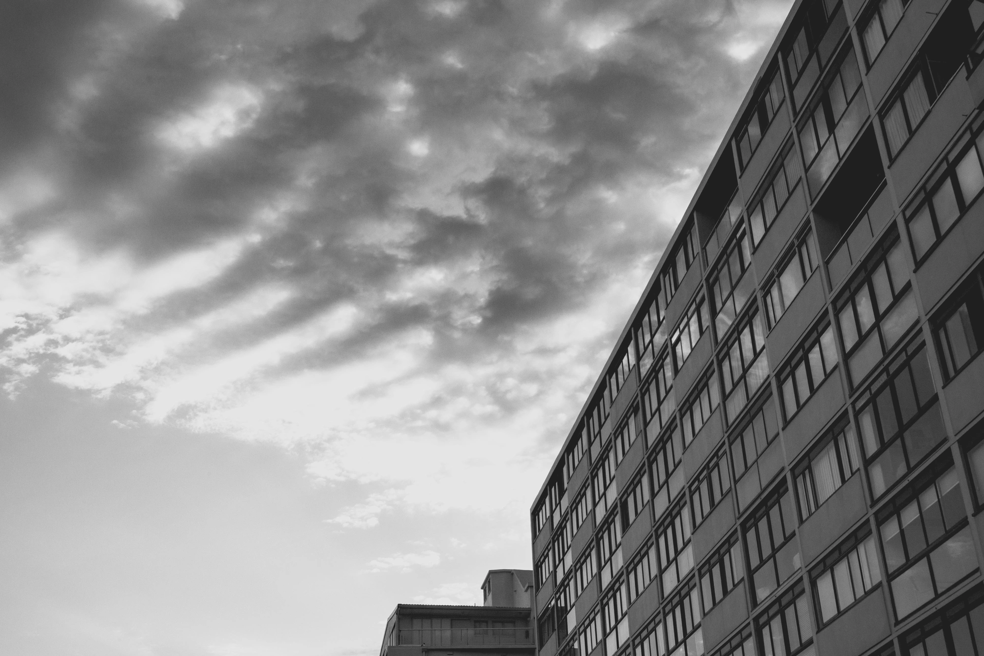 2022-02-13 - xt15-45 - bw - ZA - Cape Town - Clouds and a building with reflectins in the window