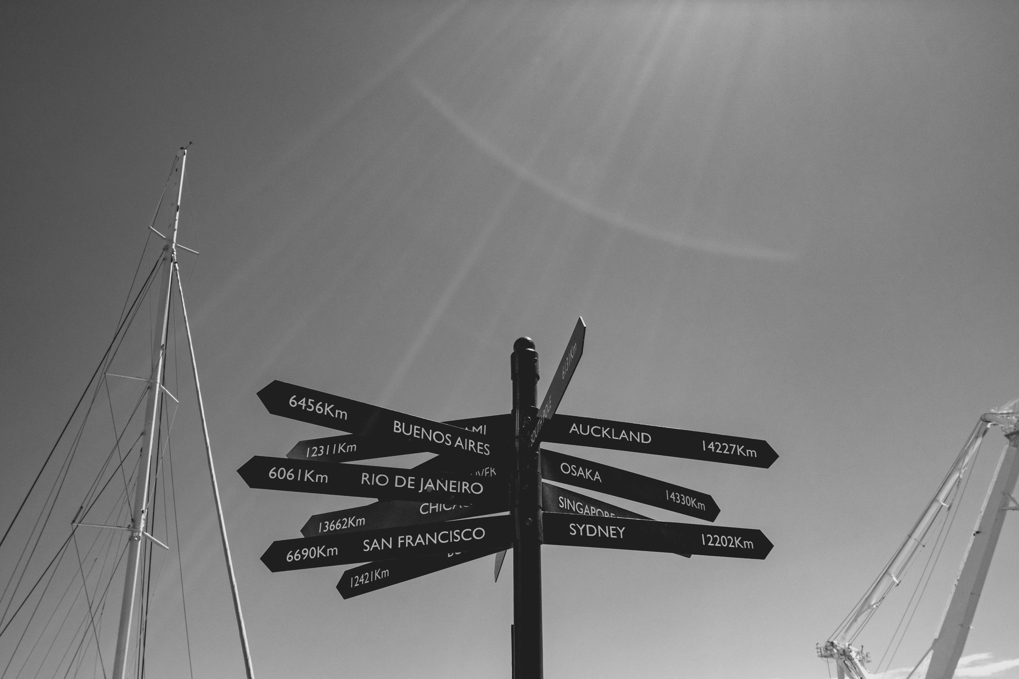 2022-02-13 - xt15-45 - bw - ZA - Cape Town - Sign pointing to different locations with the difference to them