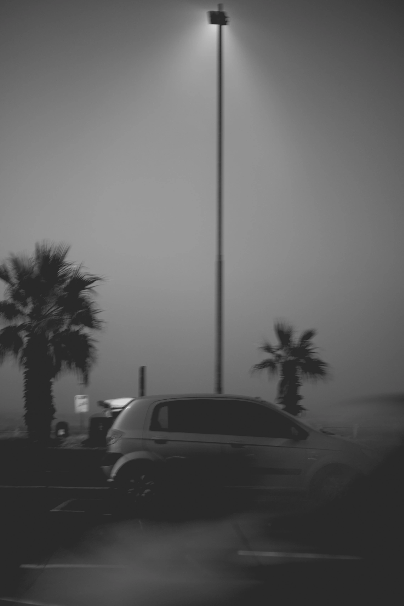 2022-02-15 - xt35 - bw - ZA - Cape Town - Car passes beneath street light on misty day