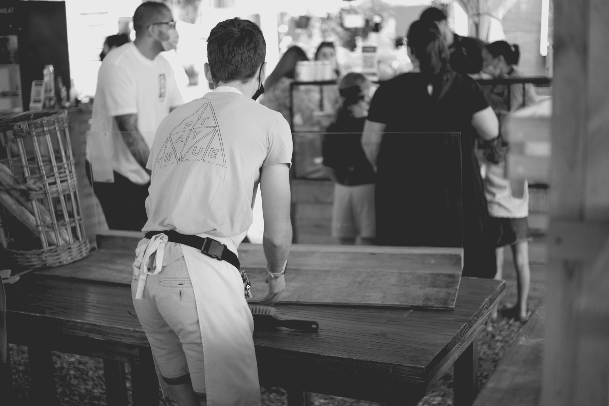 2022-02-18 - xt35 - bw - ZA - Cape Town - Man cleans workspace at bakery