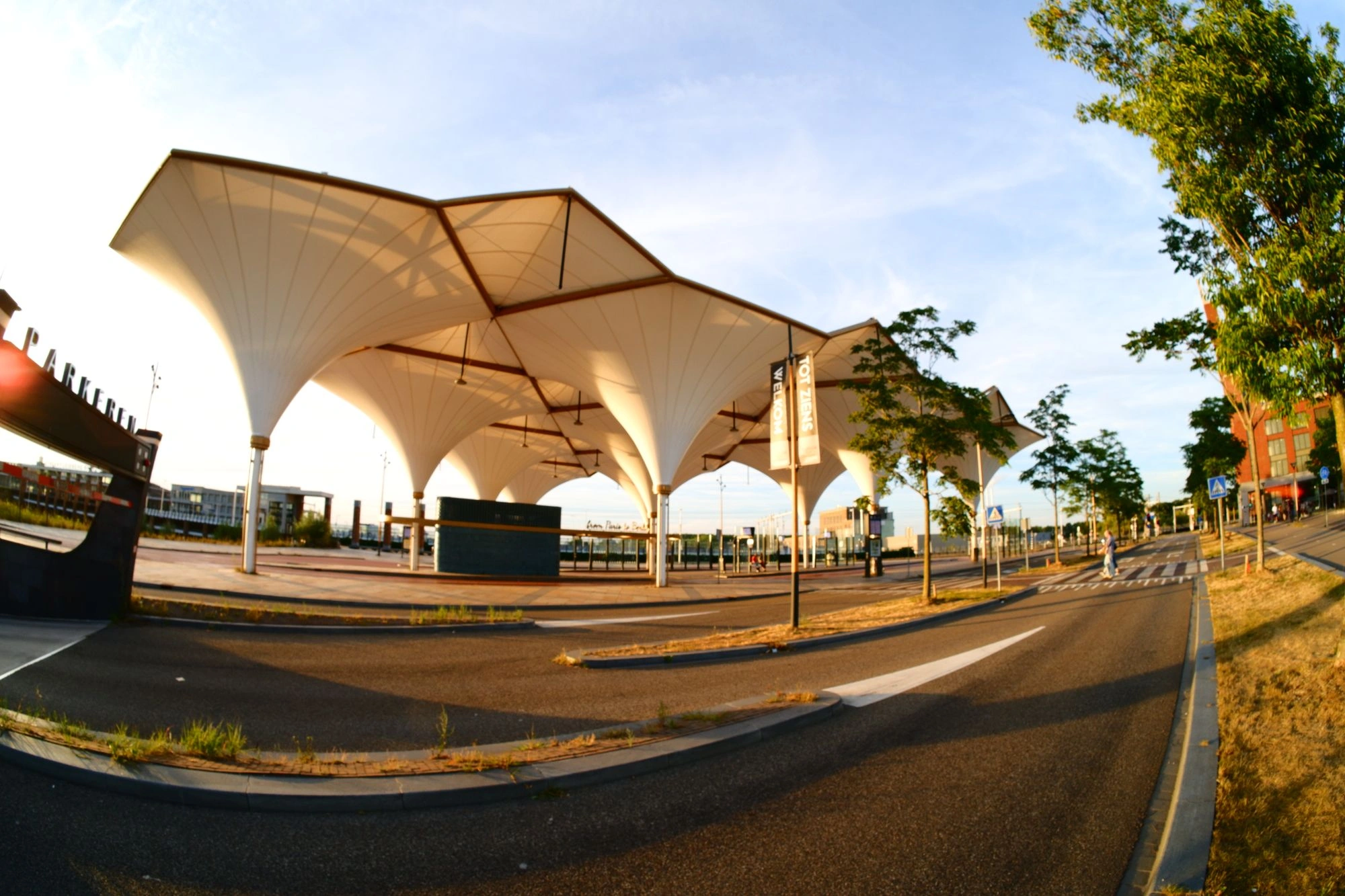 White, tent-style coverings at bus stop