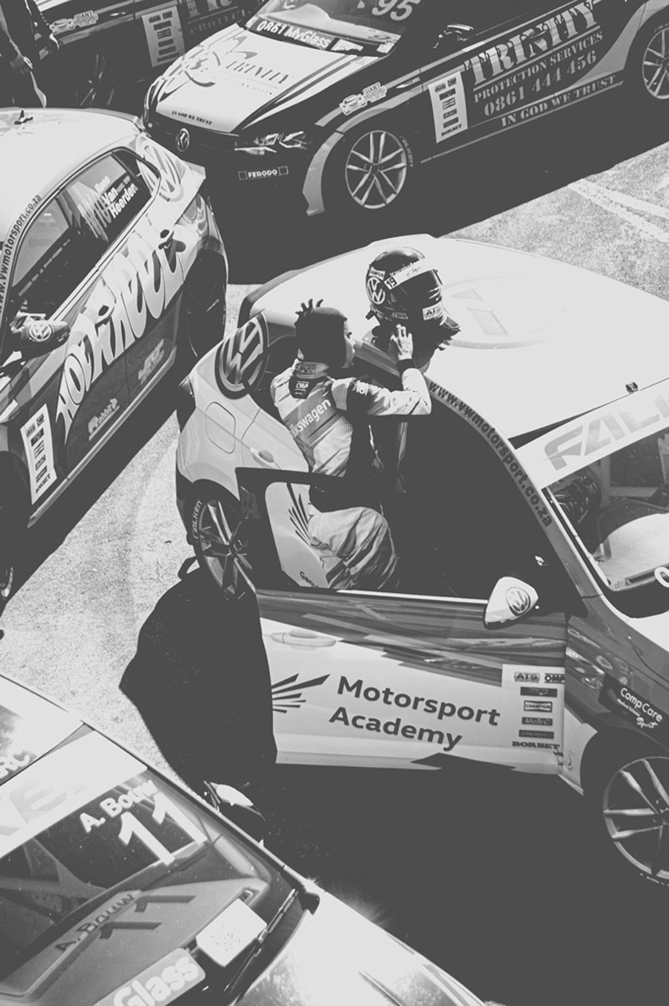 2019-07-27 - n18-55 - bw - ZA - Zwartkops Raceway - Racecar driver with helmet on car