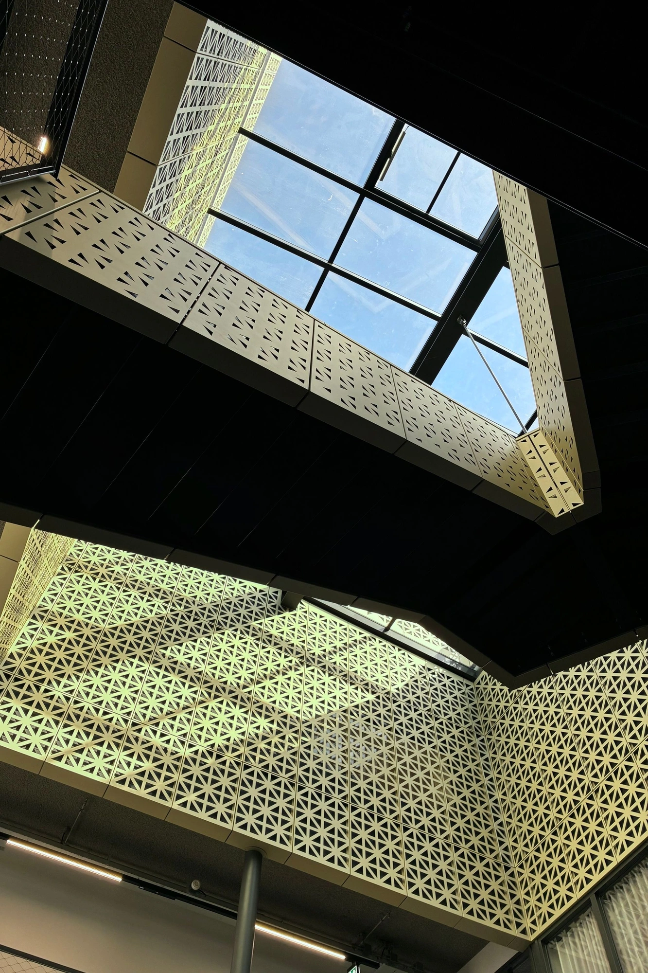 2026-03-28 - Sunlight on side of building interior with staircases criss-crossing.J