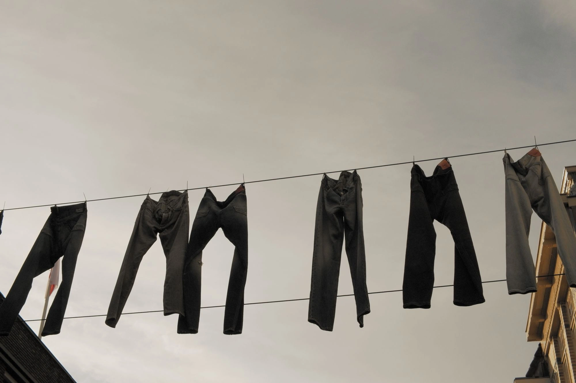 2026-05-31 - Jeans hanging between the buildings.J