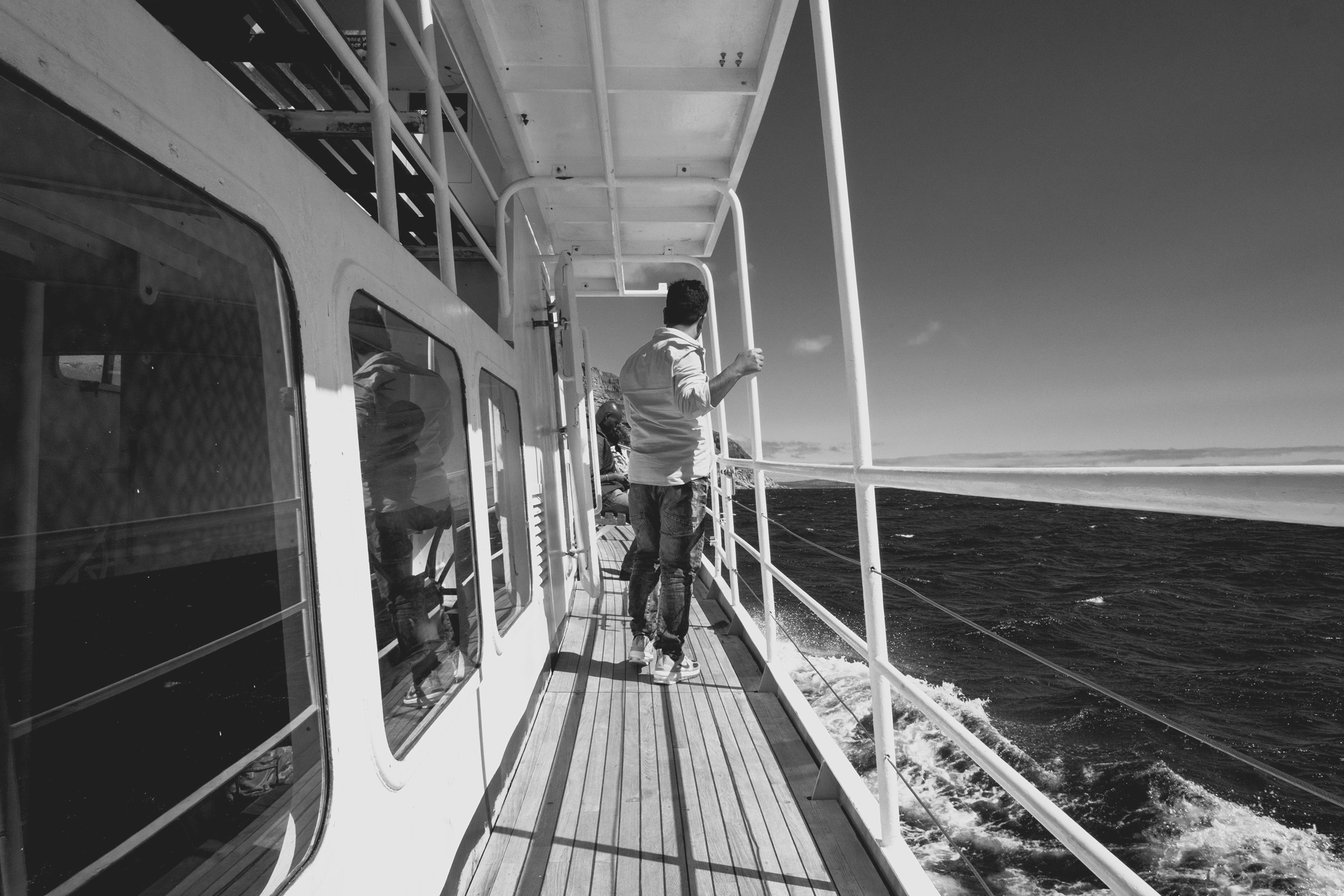 2022-02-13 - Cape Town - Man walks on walkway on boat beside the ocean.j