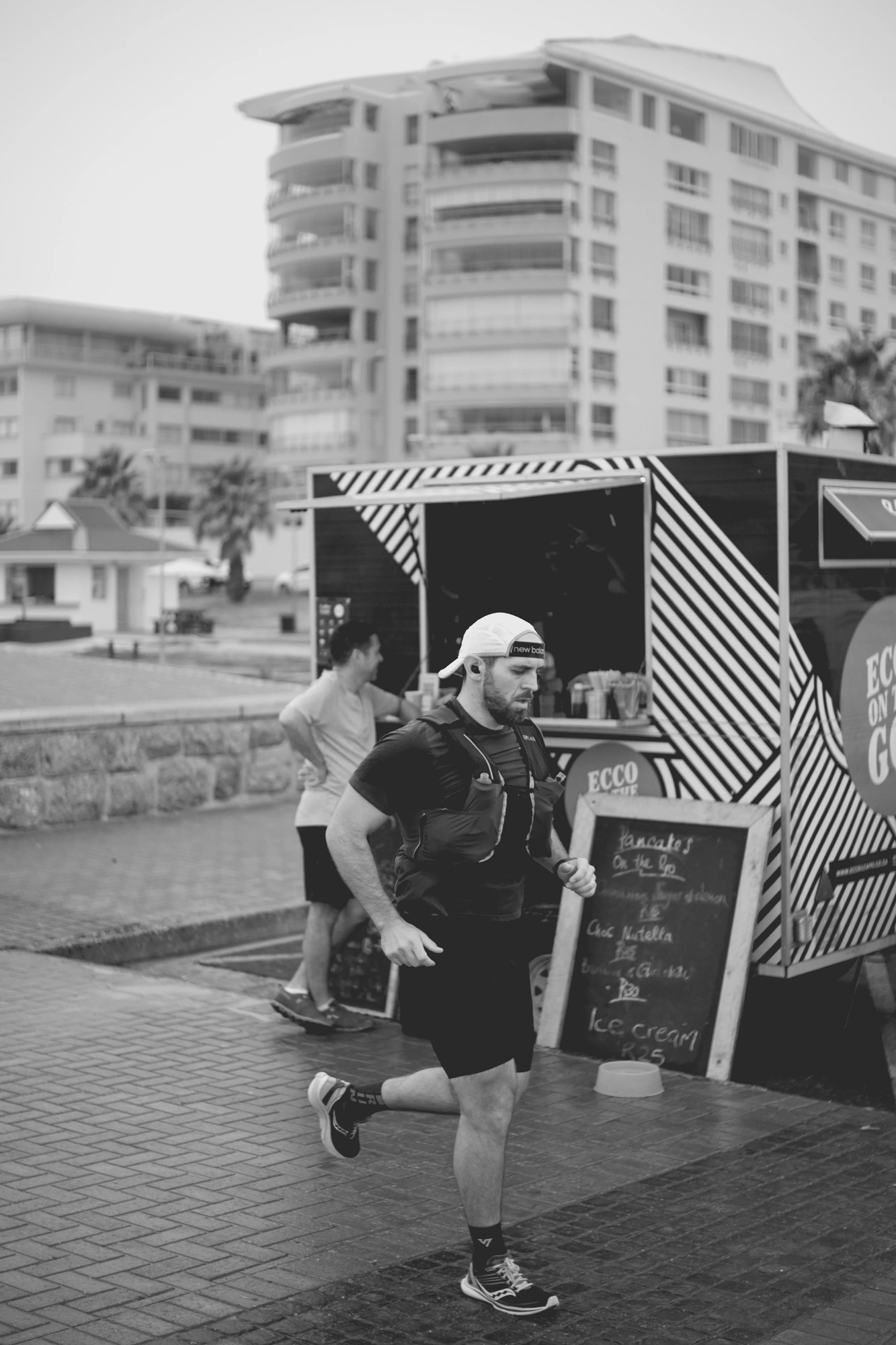 2022-02-18 - Cape Town - Man running in front of coffee cart.j