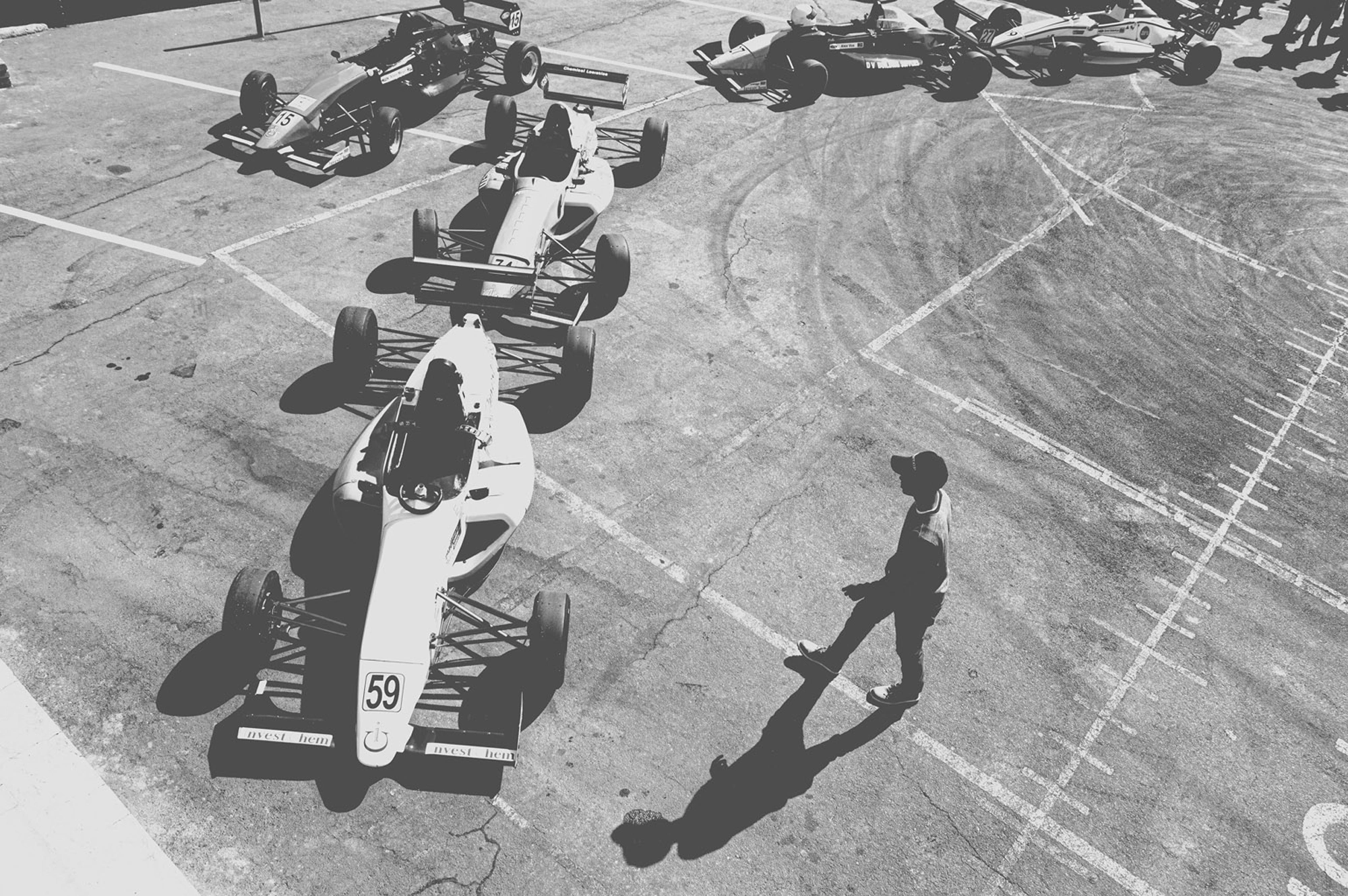 2019-07-27 - Zwartkops Raceway - Man waling next to race cars.j