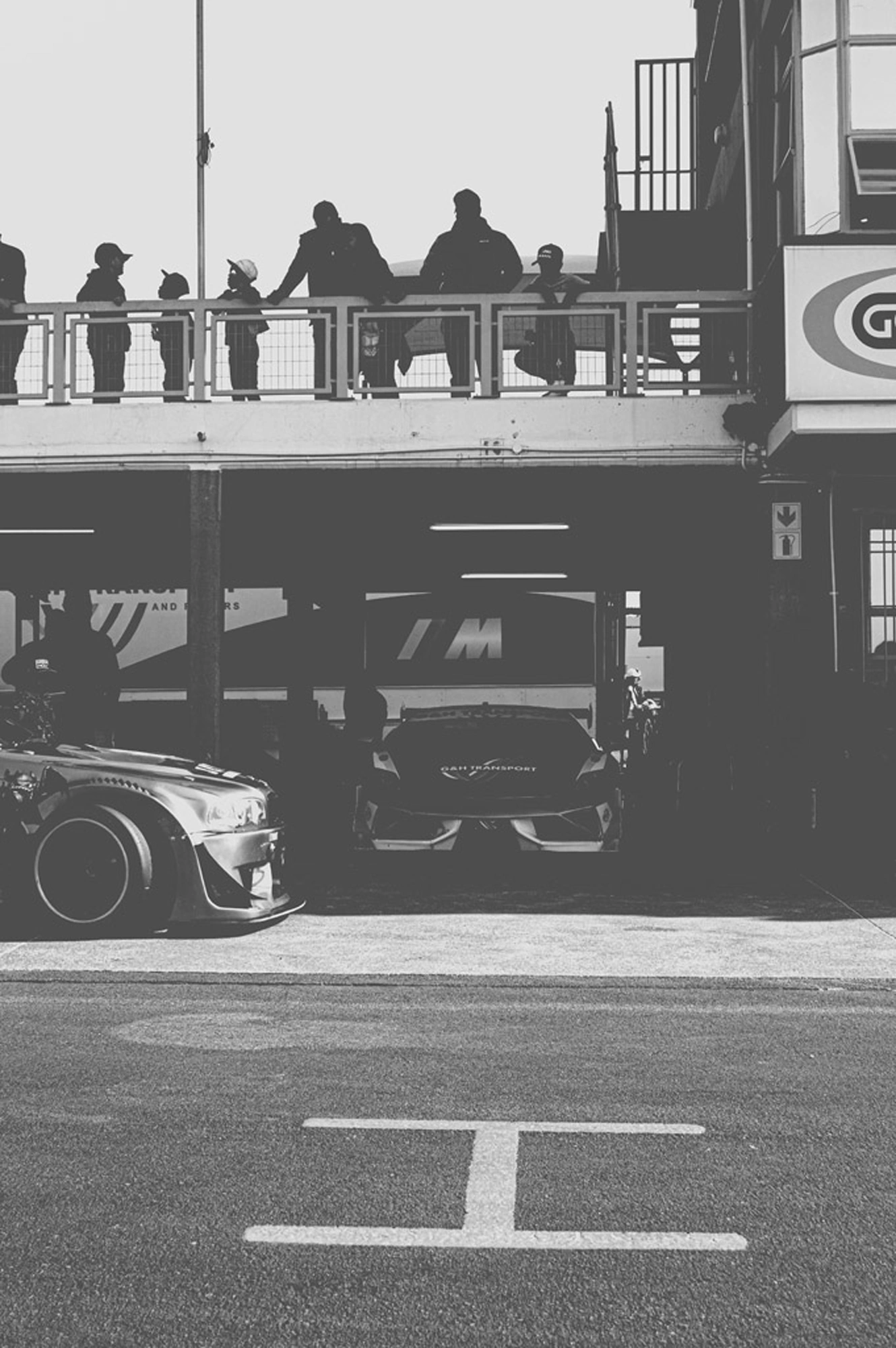 2019-07-27 - Zwartkops Raceway - Race cars in garage beside track.j