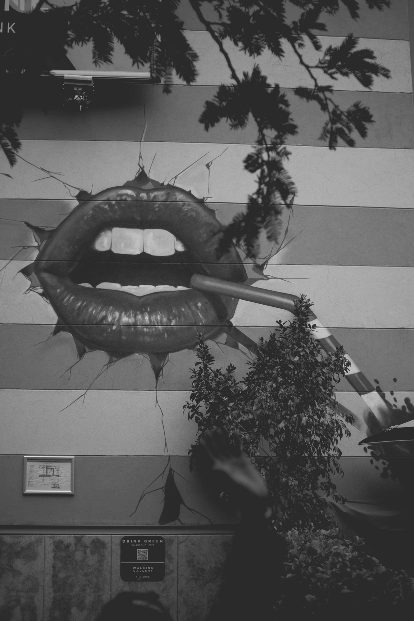 2021-12-19 - Rosebank, Johannesburg - Cigarette and lips painted on the wall, waving security guard.j
